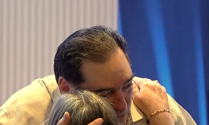 Pastor Samuel embracing a church member